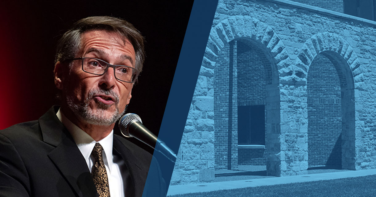 Portrait of Richard Goodbeer speaking at a microphone to the left of an image of the Hall Center for the Humanities facade