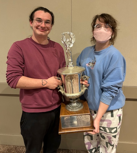 Rose Larson and Luna Schultz holding trophy.