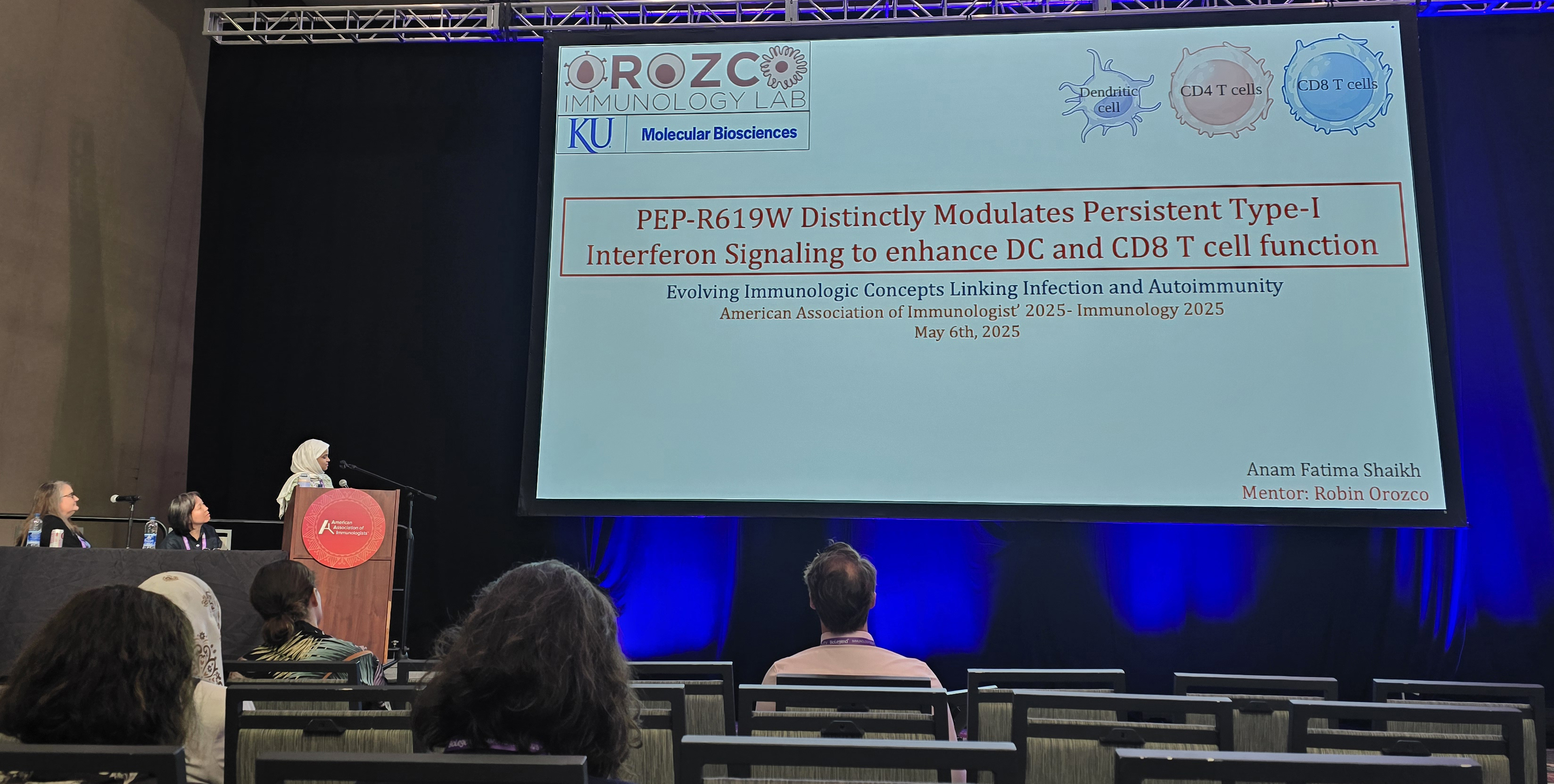 : Anam Shaikh presenting her research at the symposium