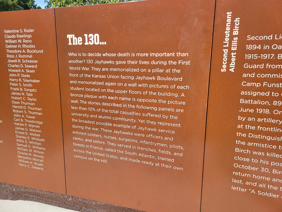 The new memorial walk features aluminum panels with the names of the 130 KU students and faculty who died, along with select stories of Jayhawk service during the war. 