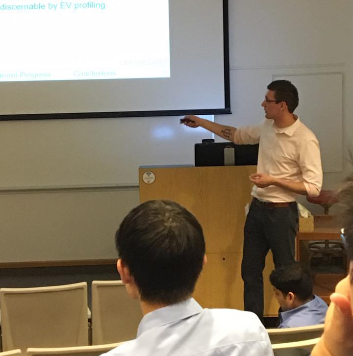 Public speaker engaging with a listening crowd in an auditorium.