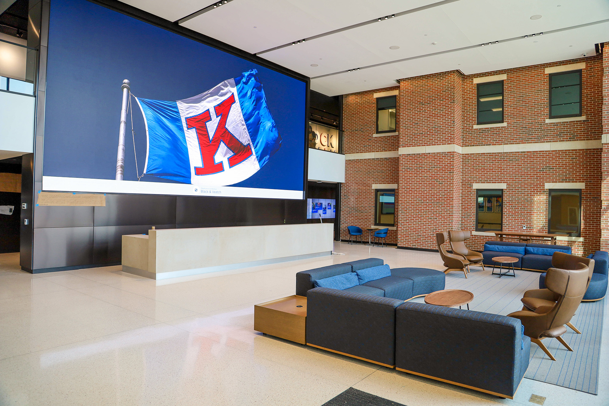 Jayhawk Welcome Center lobby featuring KU flag.