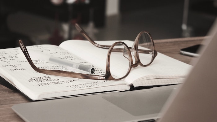 Stock image glasses on notebook.