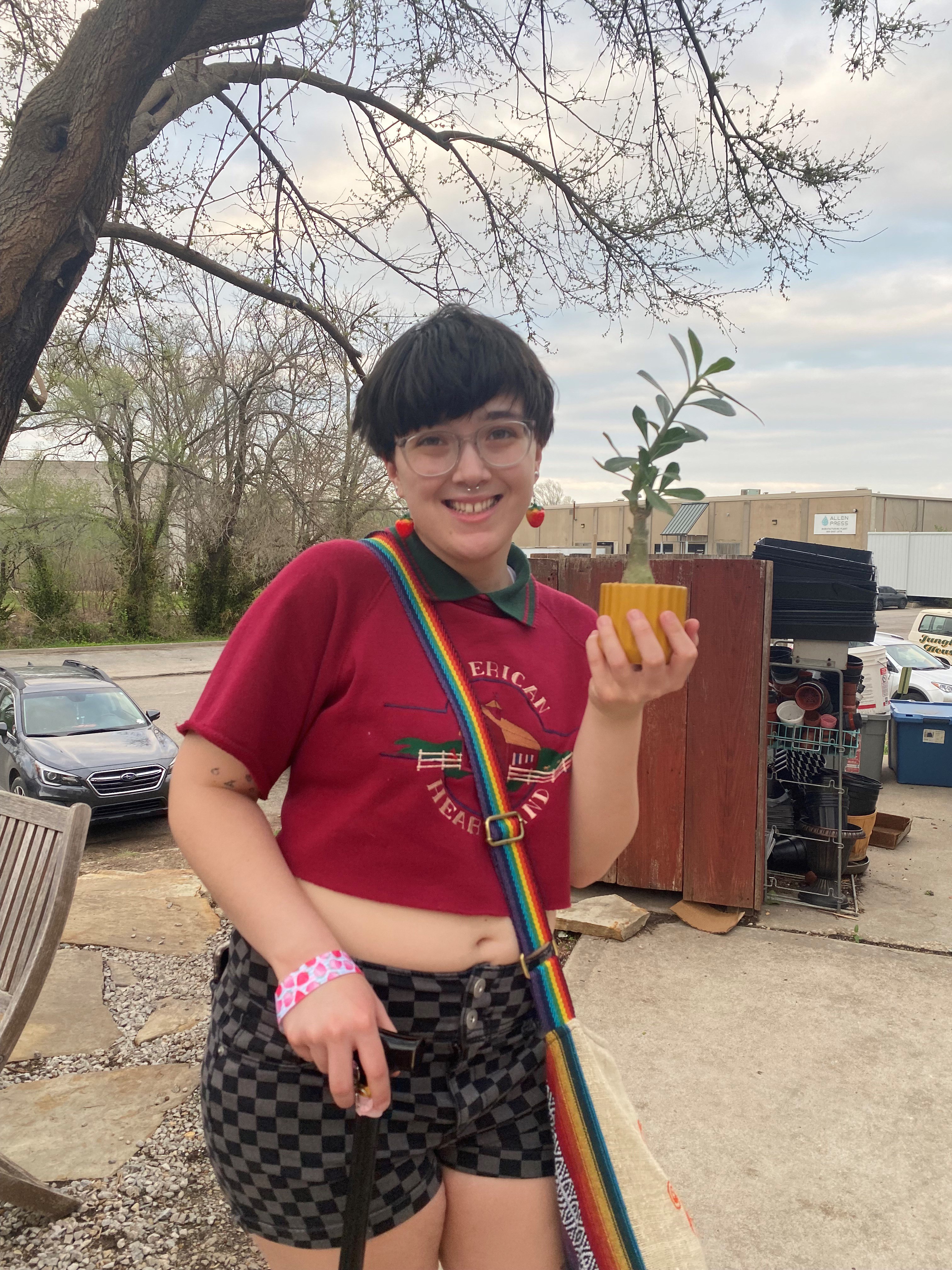 Hannah Reid holding a plant