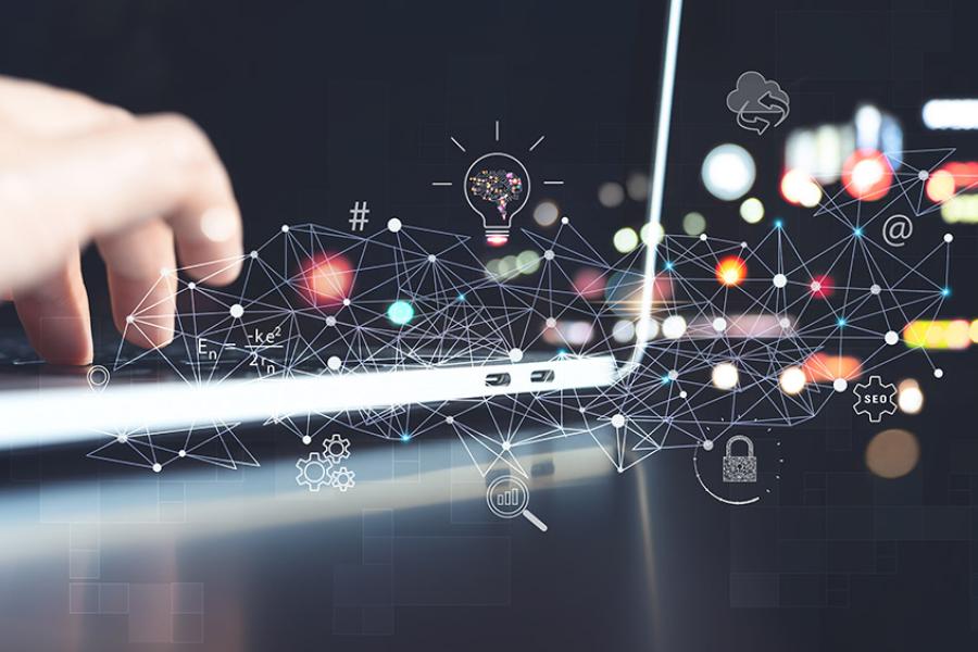 A photo illustration of a hand typing on a laptop with illustrations of technological concepts like AI and connectivity represented.