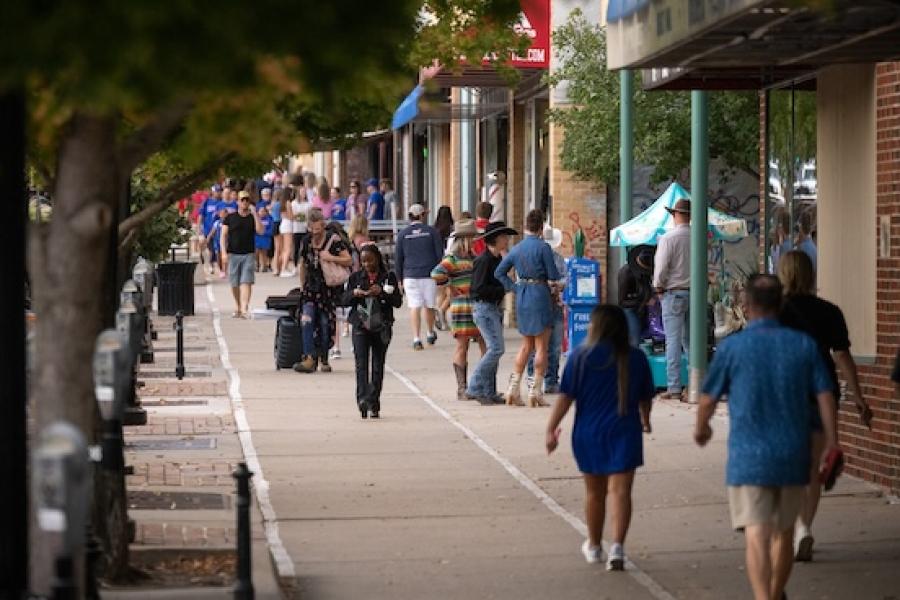 Individuals walk along downtown Lawrence.