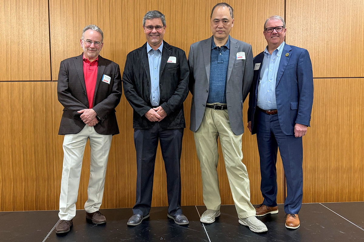 AAAS fellows Michael Wolfe, Chris Beard and Jianming Qiu in a photo with Chancellor Douglas A. Girod during a spring AAAS meeting.