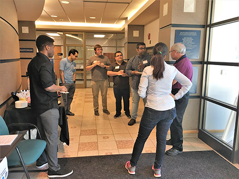 Workshop participants from the University of Arkansas, University of Kansas, and Louisiana State University enjoy breakfast and networking before the talks begin.