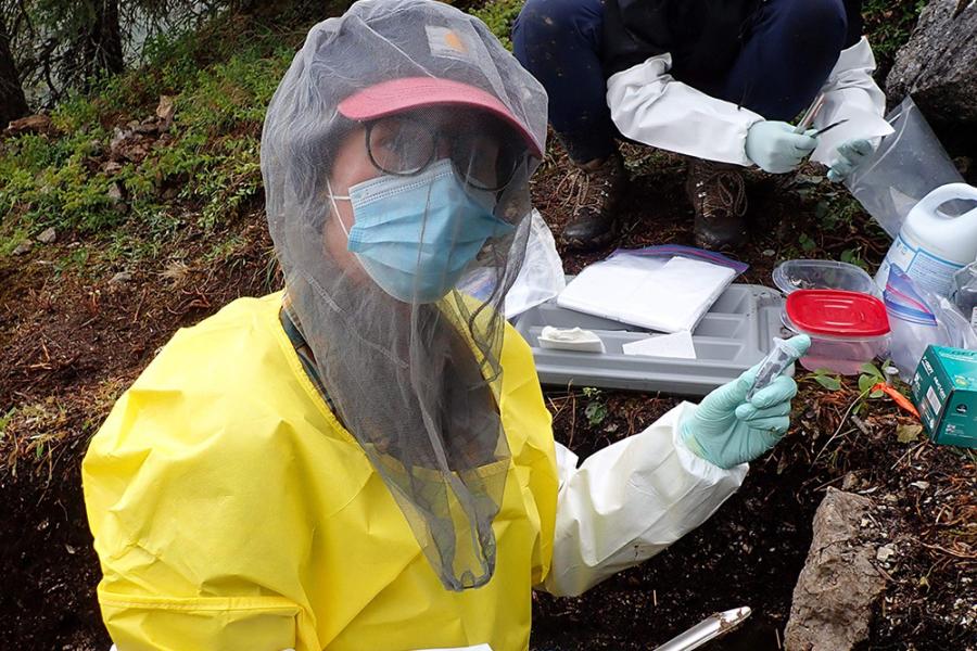 Two people collecting sediment samples at a test unit.