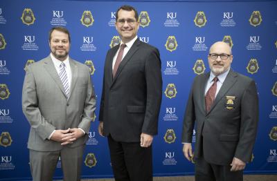 From left, Office Nicholas Yeagar, Kansas Attorney General Derek Schmidt and KLETC Executive Director Darin Beck.