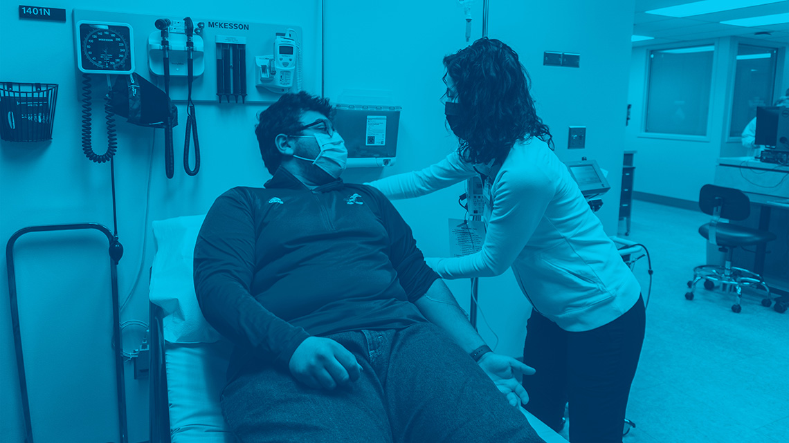 Patient getting an IV from a Watkins nurse