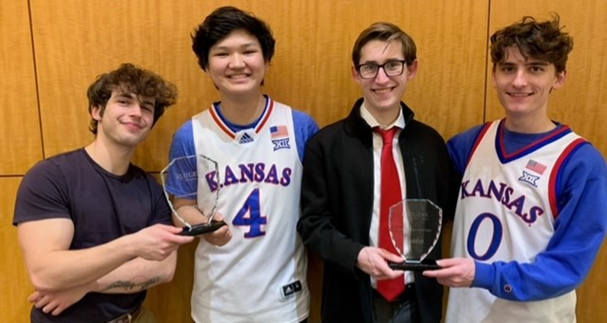 From left: Graham Revare, Jiyoon Park, Will Soper, John Marshall. Each pair of students holds a small trophy.