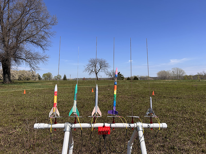 Display of small rockets outdoors.
