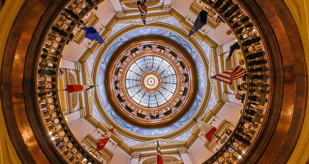 Interior view of Kansas Capitol dome with glass and flags.