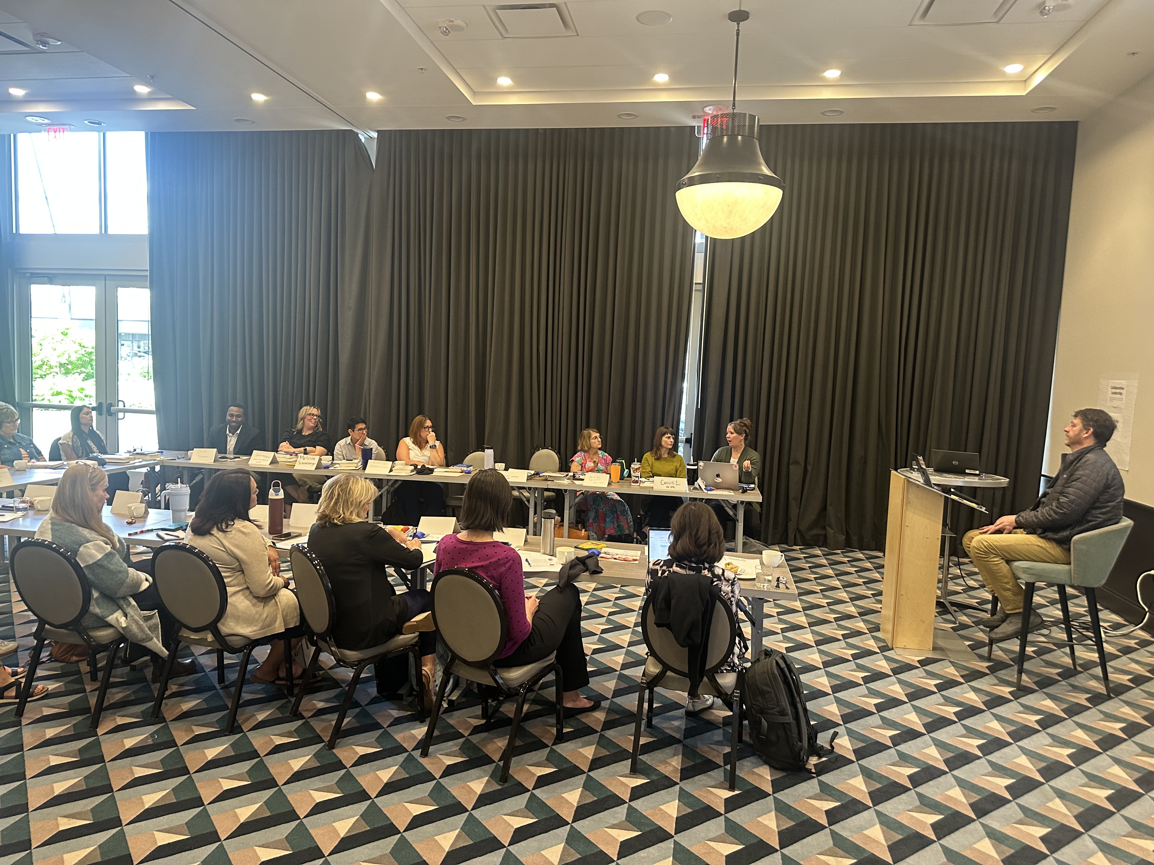 Kansas Future Fellows sit at tables for a discussion led by Jake Dunagan