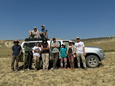 A group picture of the entire field crew in front of one of our field vehicles