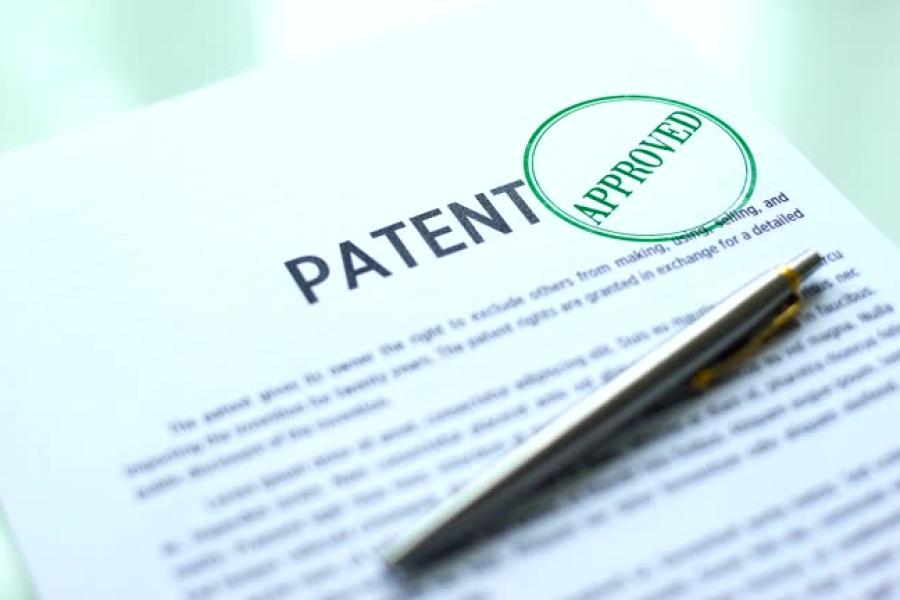 pen with paper that says patent