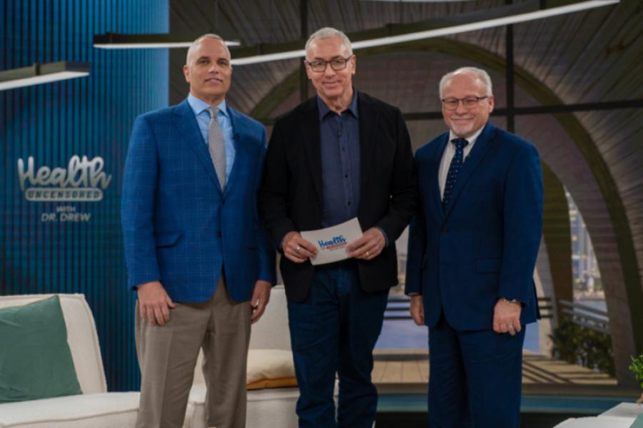 Medium close group photo of, from left to right, Greg Studdard, Dr. Drew Pinksy, and Professor Steven Soper on the set of Health Uncensored