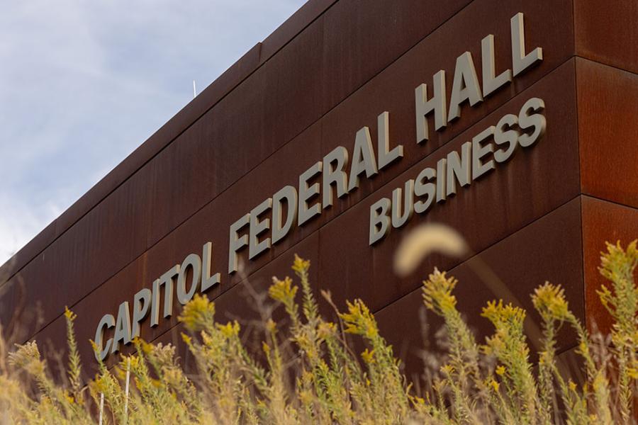 Capitol Federal Hall with signage and grass in foreground.