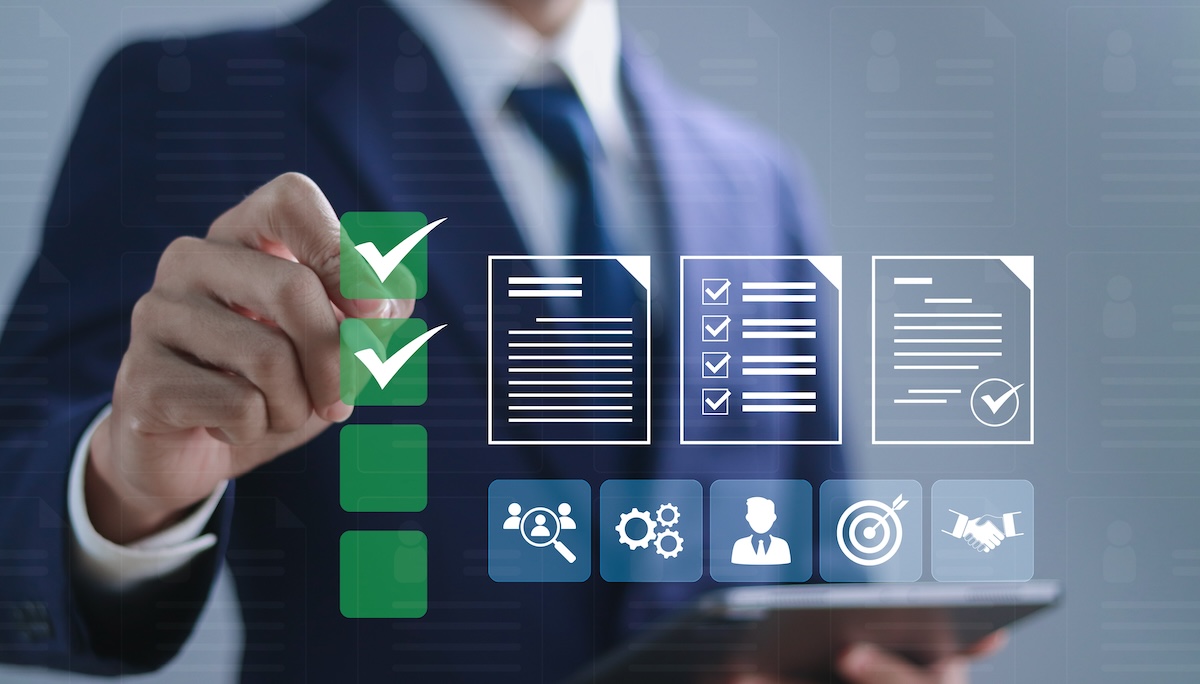 An individual wearing a suit checks boxes that denote his skills while an assortment of images involving those skills hover in front of him.