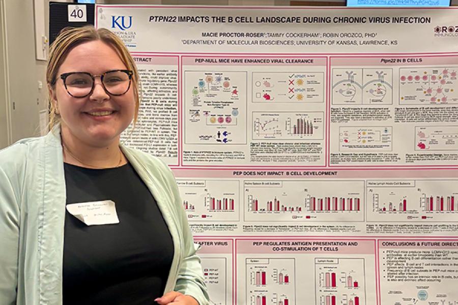 Macie Proctor-Roser stands in front of her presentation poster