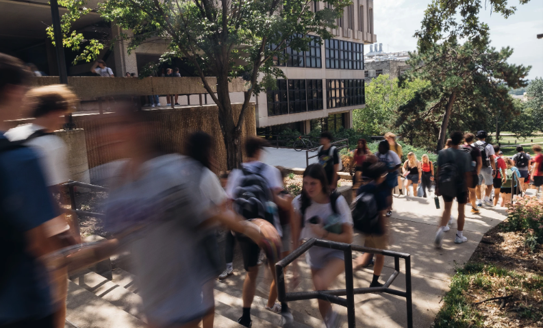 Students climb stairs beside Wescoe Hall on warm September day at the University of Kansas Lawrence campus.