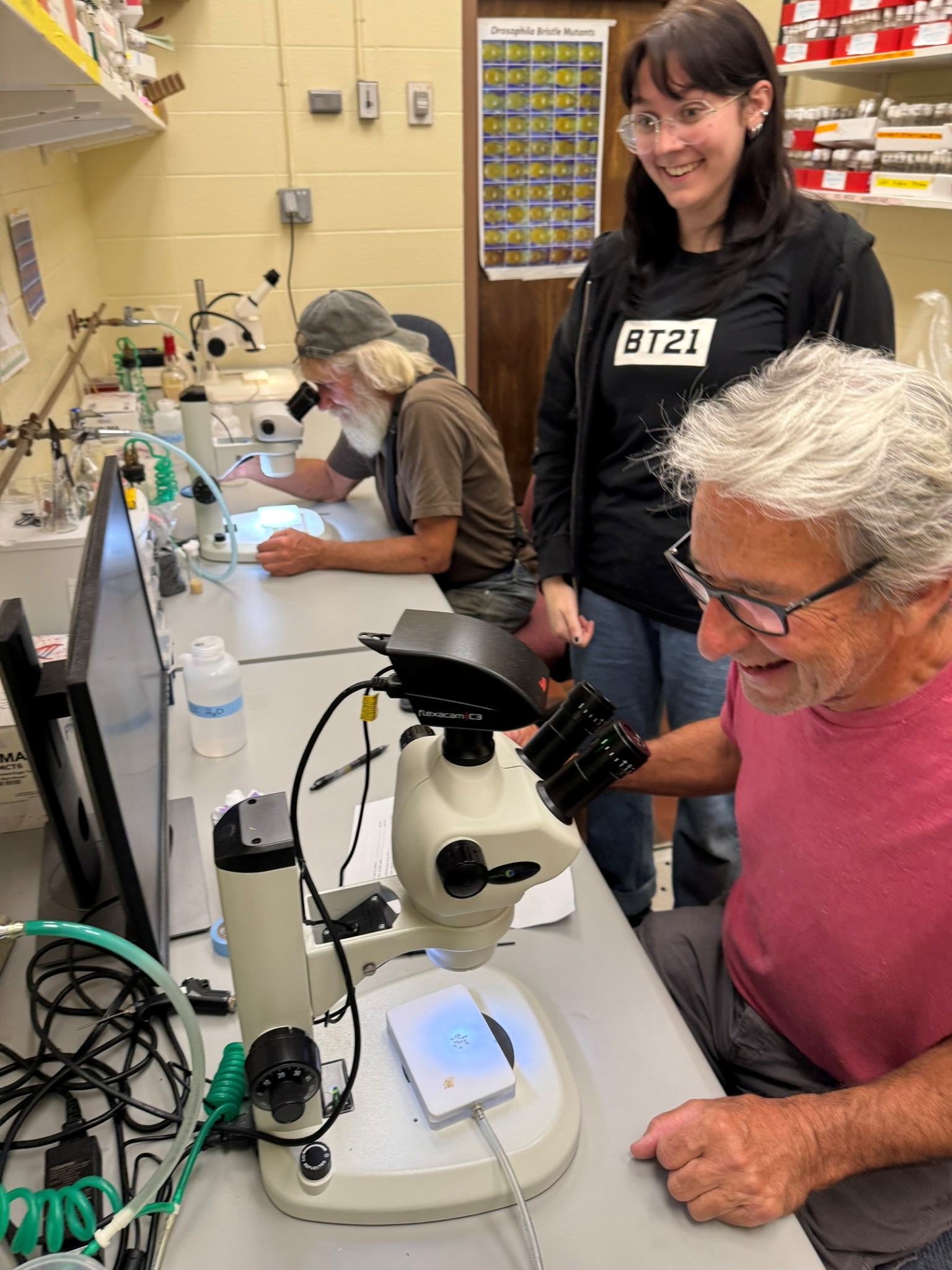 Ashley Bentz with farmer, practicing microscopy