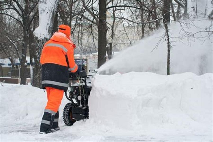 Worker removing snow