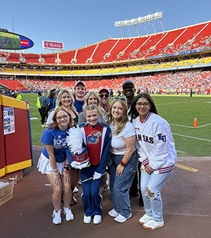 Members of the 2024 KU Homecoming Steering Committee gather on GEHA Field at Arrowhead Stadium in Kansas City, Missouri.