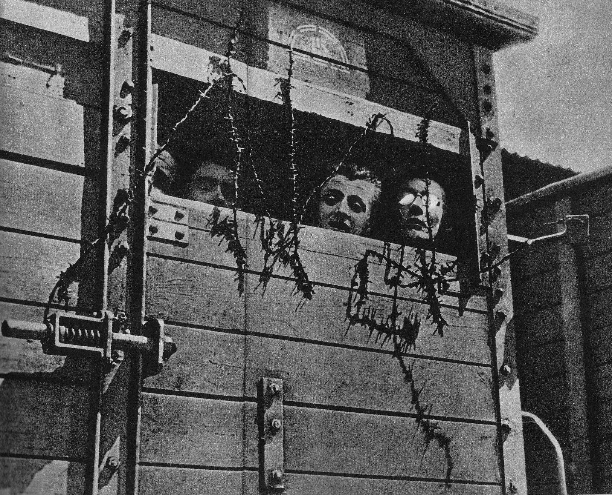 Polish Jews travel in a railway car to a death camp during World War II. Place and date unknown, via WikiCommons.