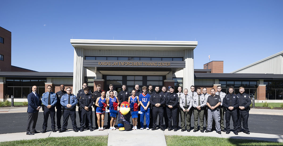 KLETC graduating class in uniform with KU cheerleaders and KLETC leaders at the Yoder campus.