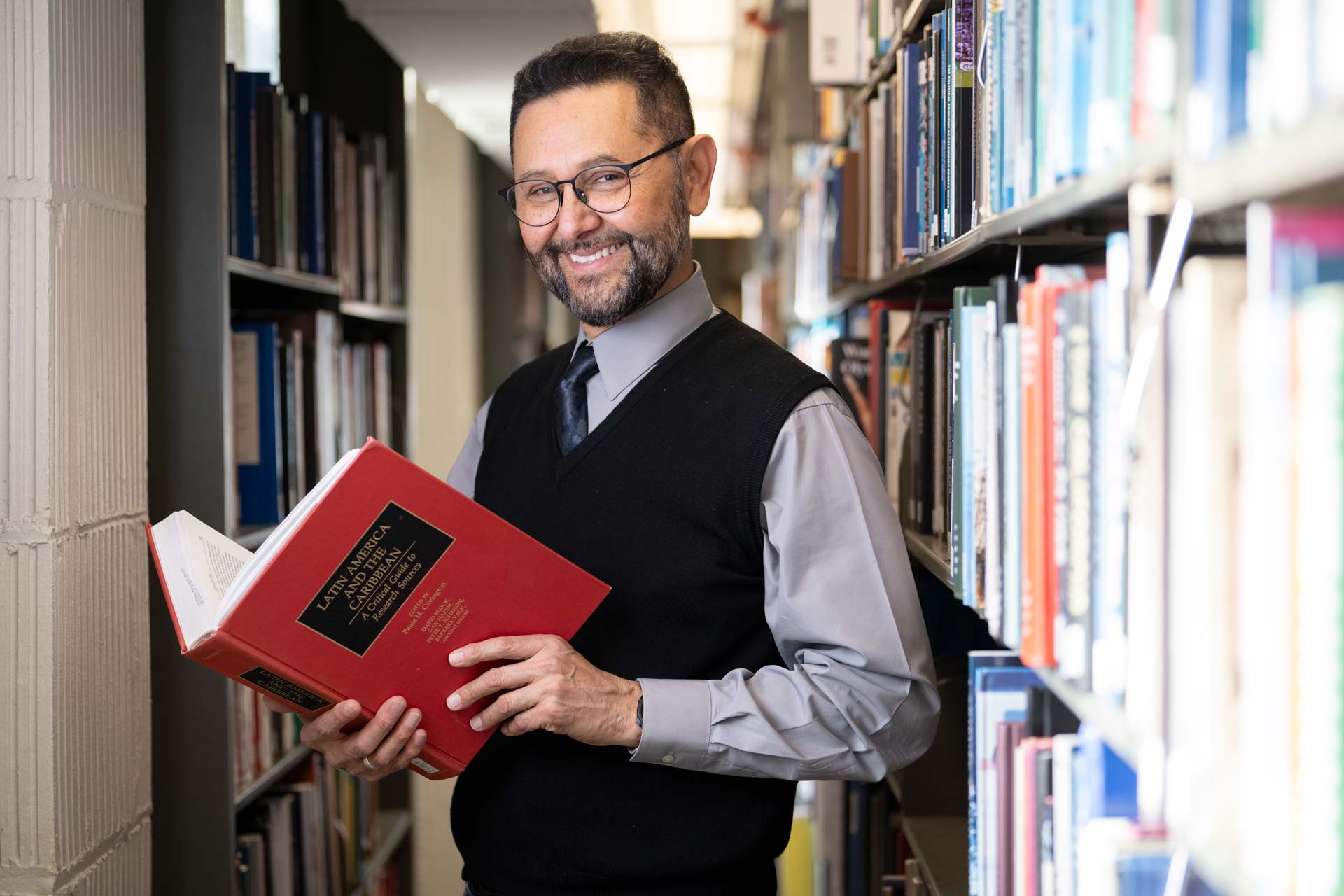 Milton Machuca-Galvez in the Watson Library stacks.