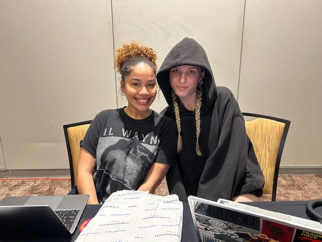 Brooklynn Hato and A.J. Persinger seated with laptops at table..
