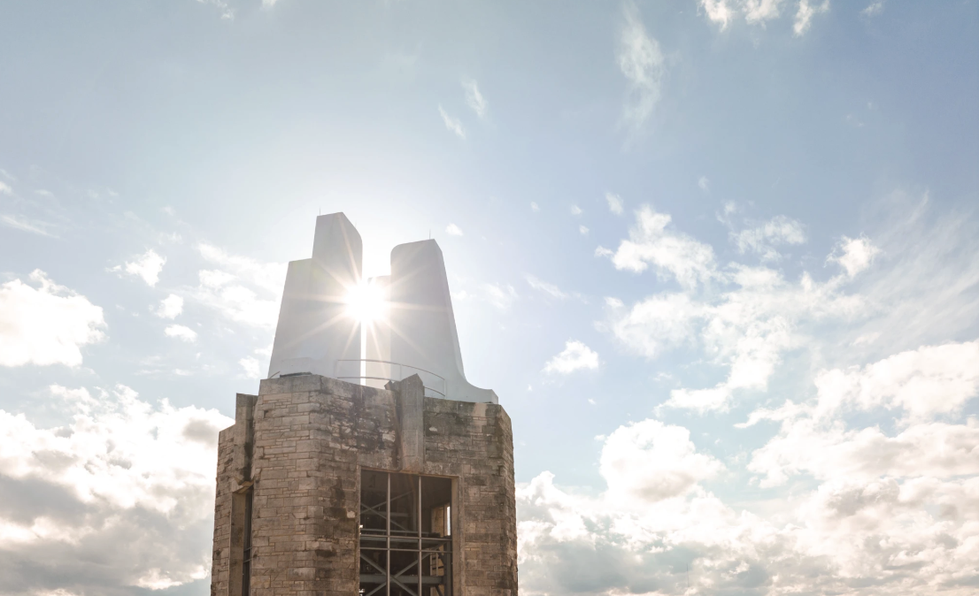 Sun peeks through clouds near Campanile at the University of Kansas.