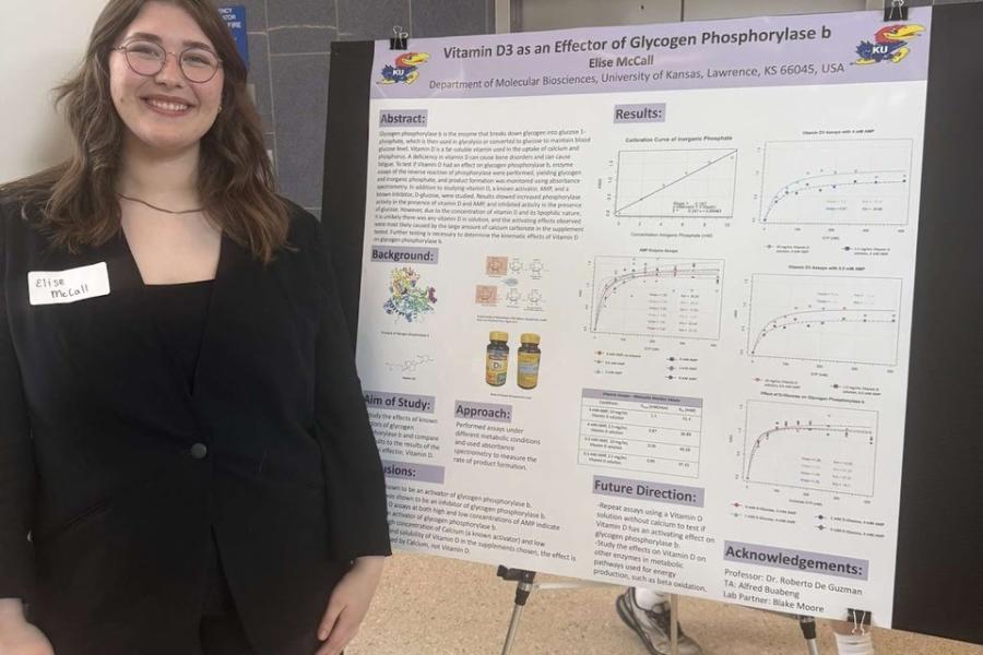 Elise McCall beside her poster
