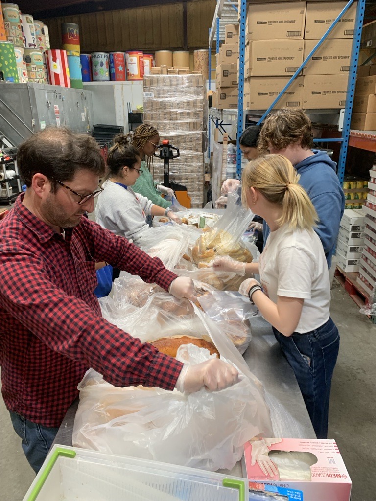 Instructor and his students help at food bank