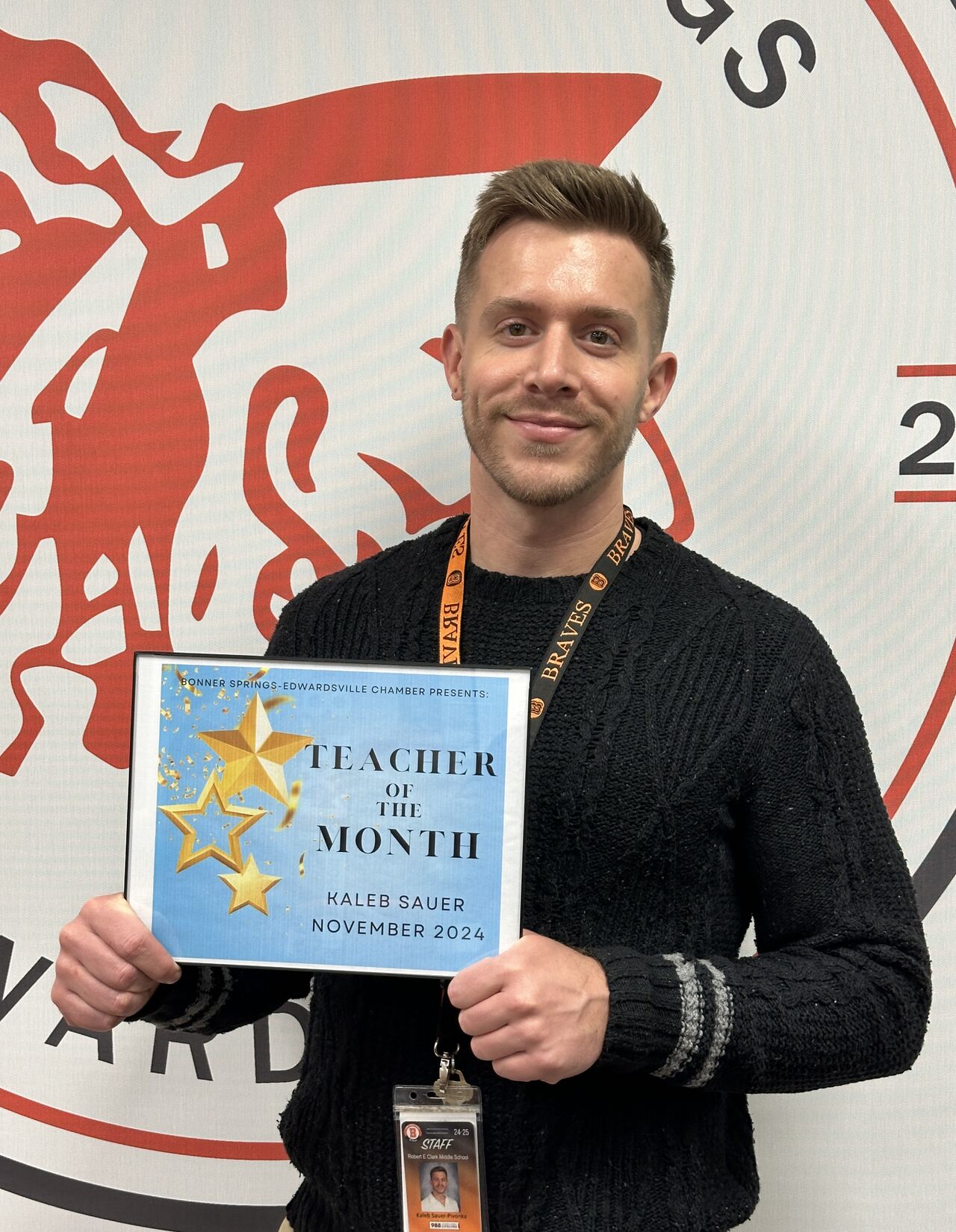 Kaleb Sauer holding a teacher of the month certificate for November 2024.