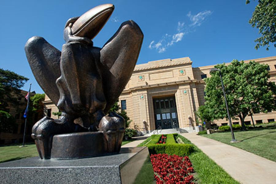 Academic Jay statue in front of Strong Hall in sprintime