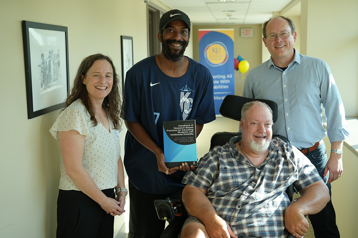 A photo of four of the book's editors and contributing authors.