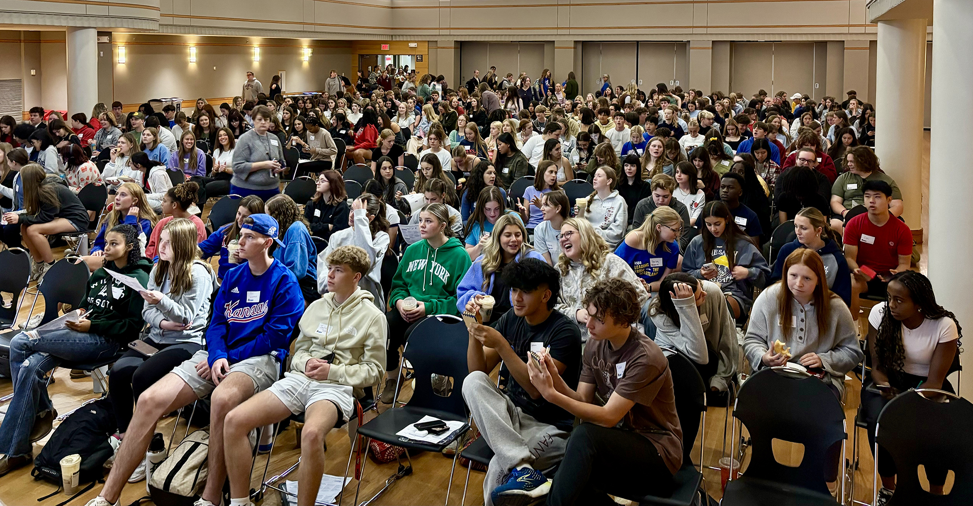 Crowd of students in auditorium.