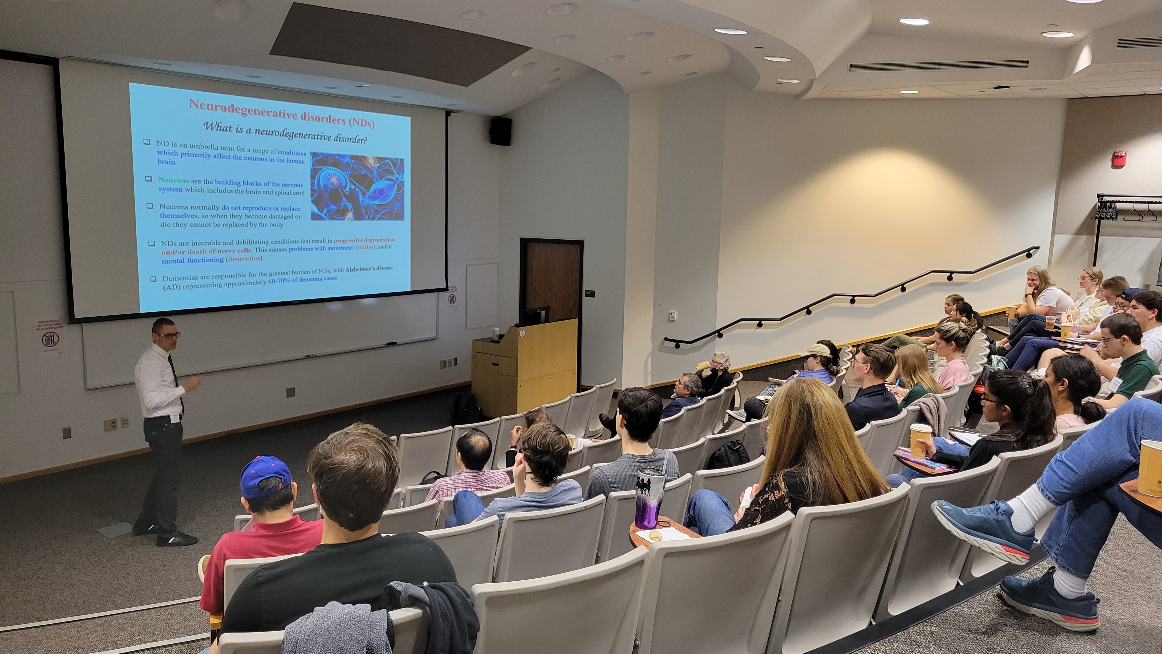 researcher presenting to audience in lecture hall