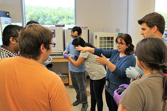 The group listen to Maggie before putting their chips in the drying oven.