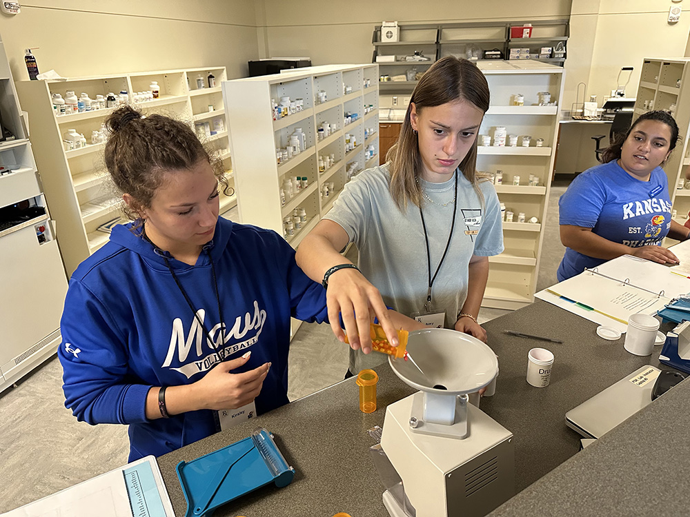 KU Pharmacy and high school students work together in KU Pharmacy Summer Camp Lab in 2023.