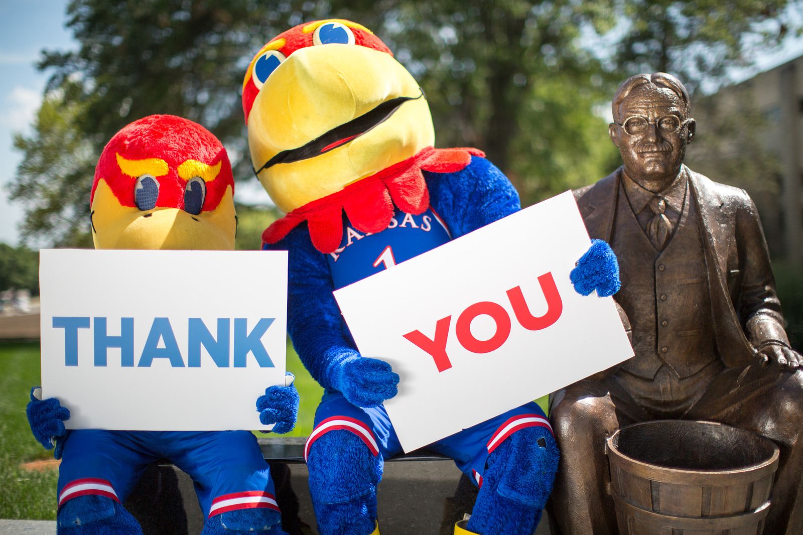 Baby Jay and Big Jay mascots holding signs that read Thank You