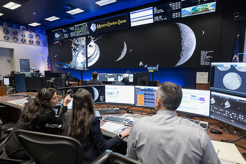 Science officers with NASA monitor data from the Artemis II mission.