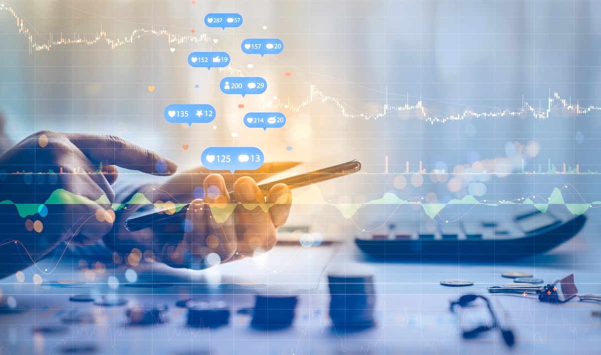 A hand holding a phone is shown liking posts on social media while a stock market graph is superimposed over the image.
