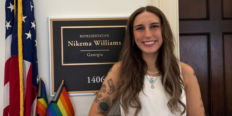 Natalie Miller stands in front of the office of Georgia Congresswoman Nikema Williams