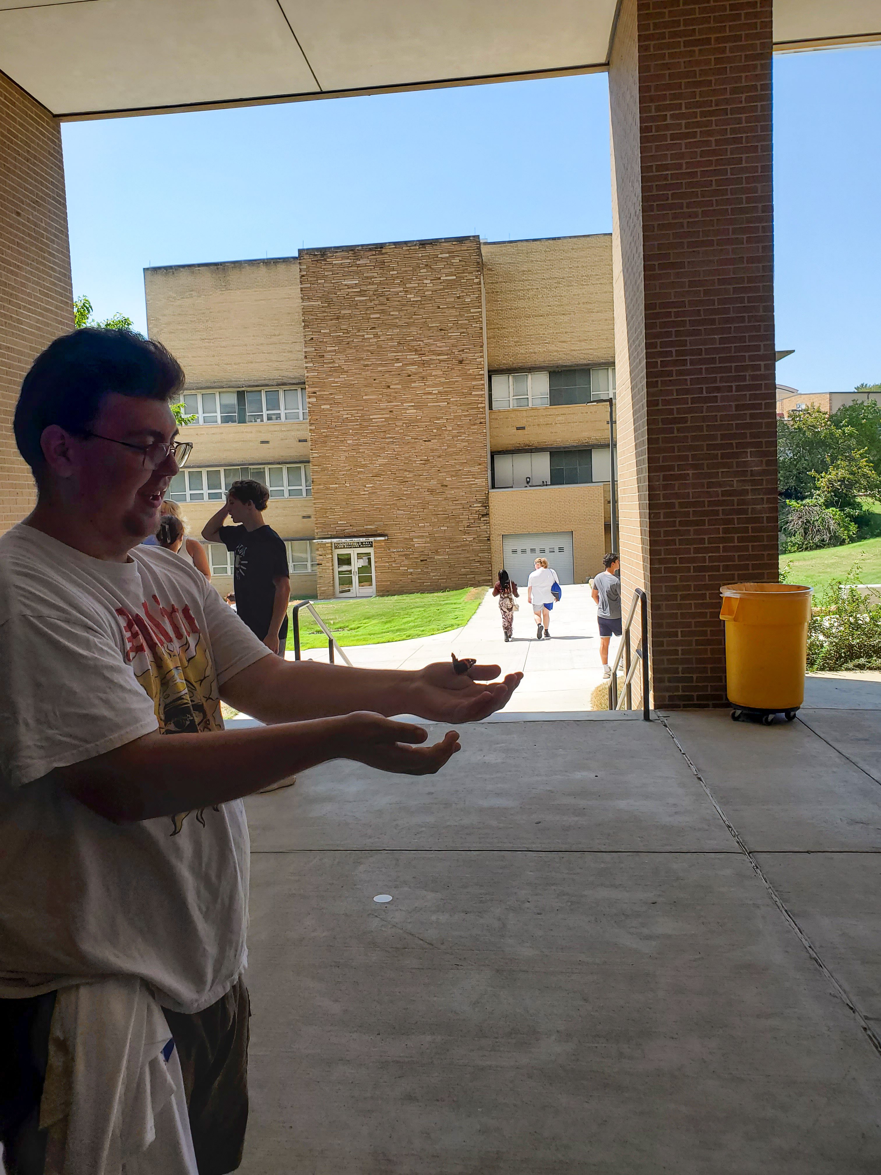 Student releases butterfly that he saved from being trapped in the Haworth Artrium