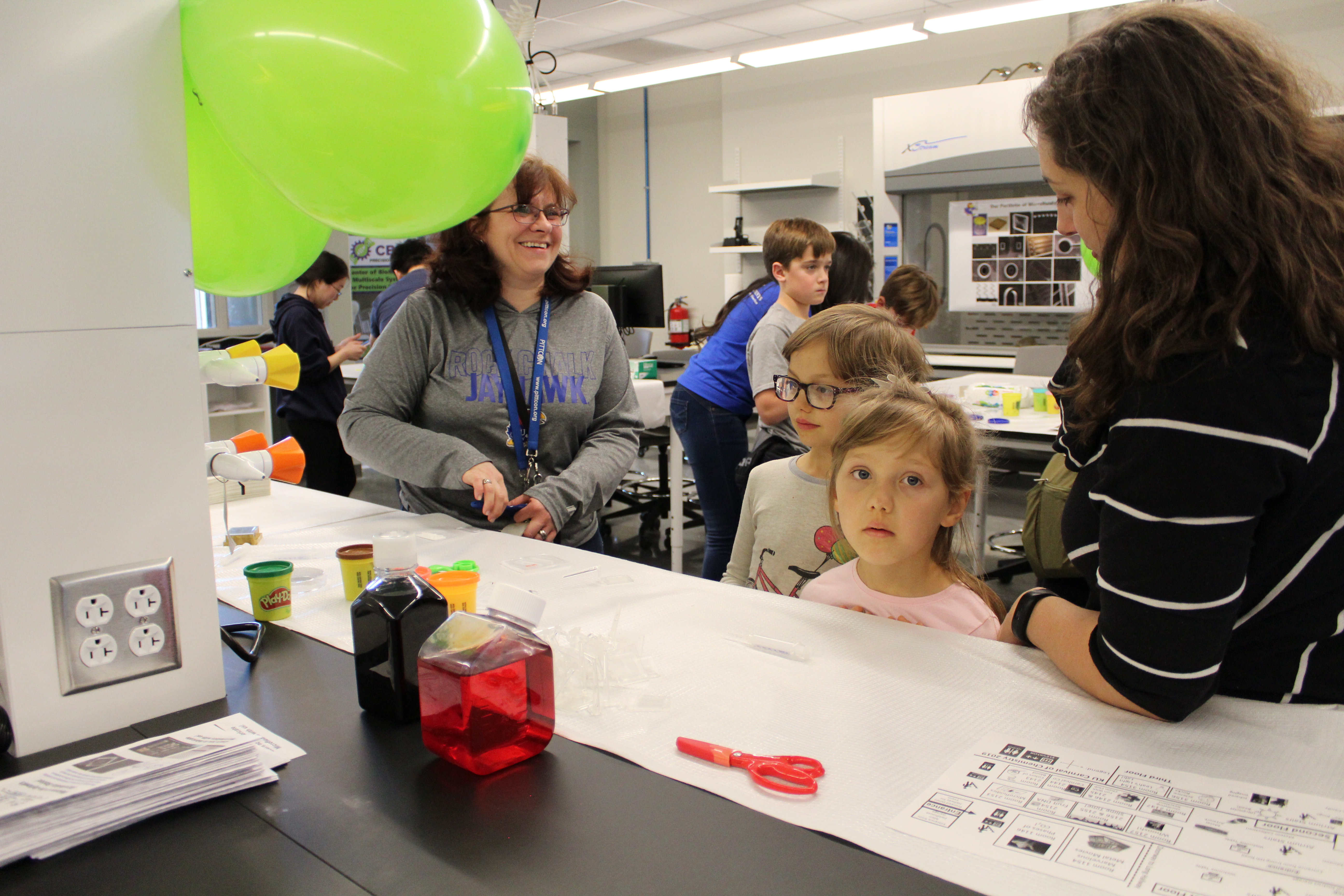 A group of people joyfully crafting together and having fun.