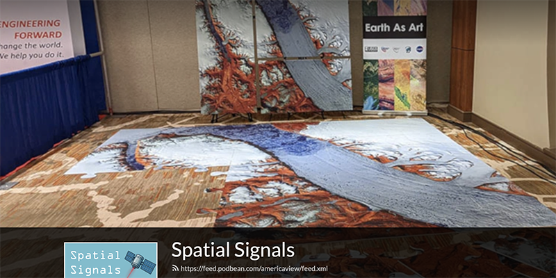 Banner image from Spatial Signals podcast website showing photo of a room with displays of a carpet, a poster and other items with satellite imagery presented as art